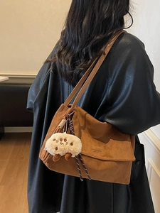 Vintage brown faux suede tote bag with double straps and a cute plush charm accessory