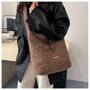 Brown fluffy wool tote bag shown on a model with warm winter style and spacious design