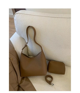 Detail of a brown lychee pattern bucket bag set with matching coin purse and strap
