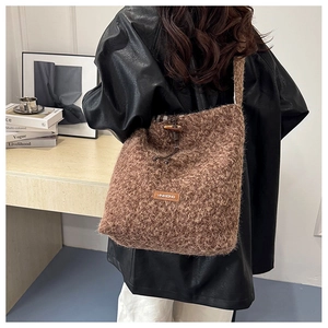 Detail of woolly brown tote bag with vintage toggle closure and plush faux fur texture