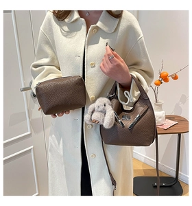 Brown lychee leather bucket bag and pouch with a cute plush bunny charm detail