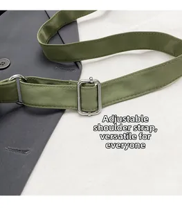 Detail of army green nylon shoulder strap with adjustable silver metal buckle
