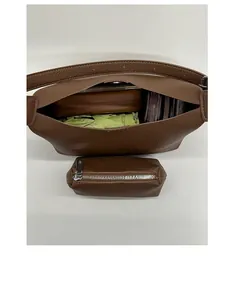 Internal capacity of brown pebble leather bucket bag with matching small zip pouch