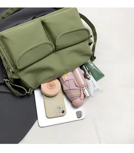 Nylon messenger bag showing spacious capacity with tablet, umbrella, and essentials