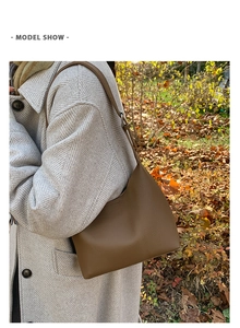 Detailed macro shot of the premium lychee pattern brown leather on the bucket shoulder bag