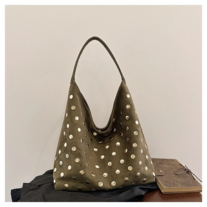 Close-up of vintage suede hobo bag with detailed metallic studs and large shoulder strap