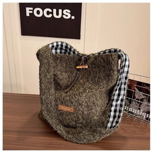 Detail of wool tote bag with olive faux fur, horn toggle closure and gingham lining