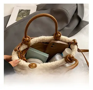 Top-down view of a spacious brown leather bucket bag with plush faux fur trim detail