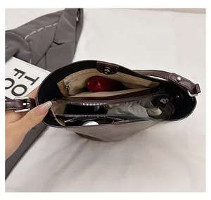 Top view of brown matte leather bucket bag showing inner space with magnetic closure
