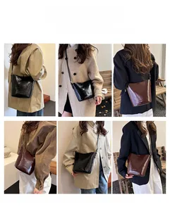 Polished leather bucket bag detail showing multiple carrying styles and shoulder strap