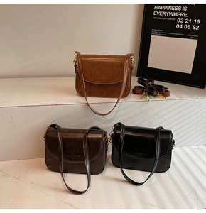 Detailed view of vintage faux leather shoulder bags in caramel, dark brown, and black colors