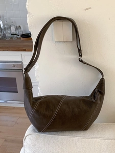 Vintage dark brown leather crescent bag with white contrast stitching and adjustable strap