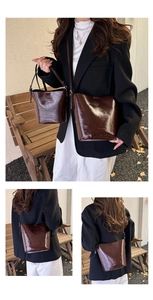 Detailed comparison of dark brown oil wax leather bucket bags in outdoor natural setting