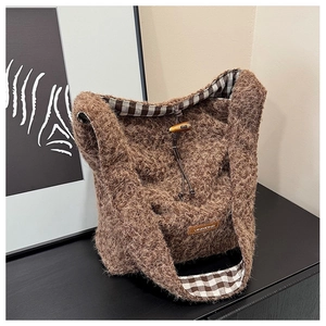 Detail of plush tote bag showing soft brown wool texture and wooden toggle closure