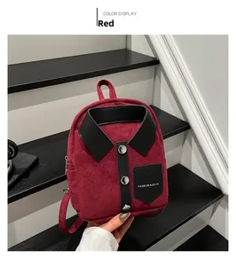 Detail view of burgundy suede mini backpack with black shirt collar design and metal buttons