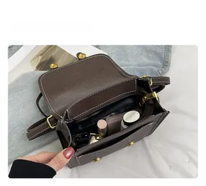 Interior view of the vintage brown crossbody bag showing storage capacity for daily items