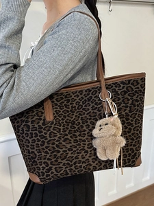 Chic leopard print tote bag with brown leather trim and cute plush bear charm