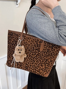 Leopard print large tote bag with bear charm pendant and brown leather shoulder straps