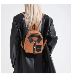Macro shot of a brown suede mini backpack with a shirt collar design on back of a model