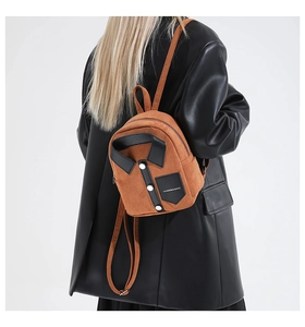 Detail of creative orange shirt-shaped backpack with collar and fashion slogan