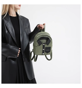 Detail of army green shirt-style mini backpack with collar design and silver buttons