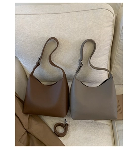 Detail of vintage hobo bucket bags in brown and taupe leather with adjustable straps