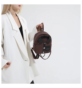 Close-up of a mini dark brown backpack with a creative shirt collar design and buttons