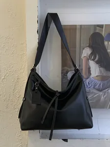 Grand sac cabas hobo noir en cuir minimaliste avec détails à cordon et une bandoulière chic