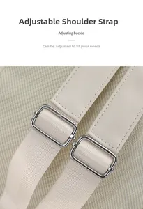 Detail of adjustable shoulder straps with silver metal buckles on beige canvas backpack