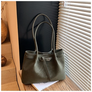 Detailed macro view of olive green matte leather tote bag with buckle strap detail