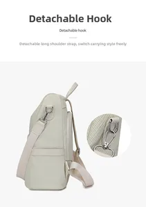 Detail of silver detachable metal hook and woven strap on minimalist cream white backpack