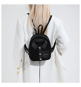 Detail of a mini black backpack with shirt collar design and silver metal buttons