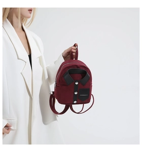 Detail of burgundy mini backpack with creative shirt collar design and silver buttons