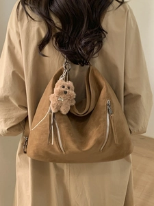 Brown suede large capacity tote bag with decorative metal zippers and plush dog charm