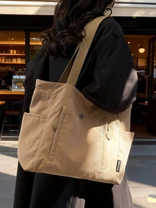 Khaki large capacity canvas tote bag with multi-pocket design for casual daily use