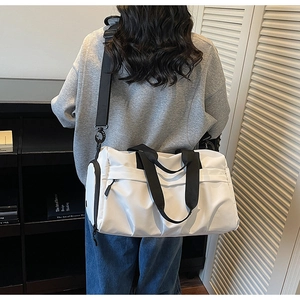 Vue arrière d'un mannequin portant un grand sac de voyage en nylon blanc avec sangles