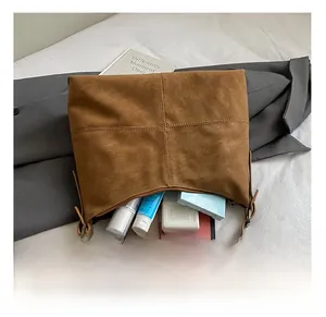 Interior view of brown vintage tote bag showing large capacity for cosmetics and phone