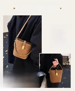Detail of a brown vintage bucket bag with gold metal buckle and dual strap options