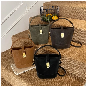 Detail view of retro bucket bags in four colors arranged on steps with props