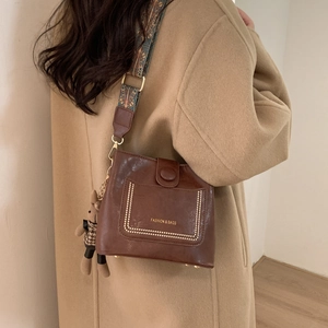 Brown retro crossbody bag with ethnic print wide strap and cute teddy bear charm
