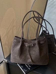 Minimalist dark brown suede leather tote bag with stylish shoulder straps and metal buckle