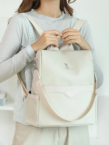 Minimalist beige women's backpack with subtle rabbit logo and spacious side pockets