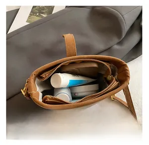 Top-down view of the interior capacity of caramel leather bucket bag with zipper