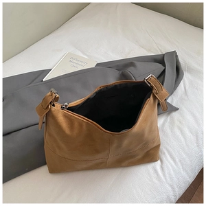 Detail view of the brown PU leather shoulder bag with zipper closure and metal buckle