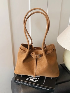 Minimalist camel suede tote bag with metal buckle detail and thin shoulder straps
