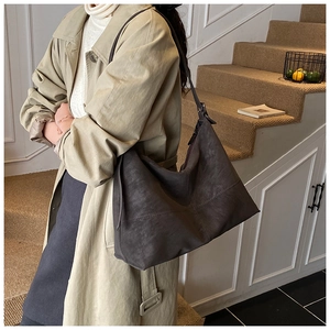 Detail of vintage dark brown large capacity hobo bag with adjustable shoulder strap