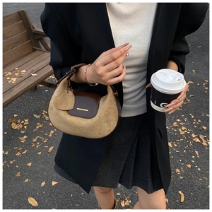Chic brown suede hobo bag shown in street style setting with leather details