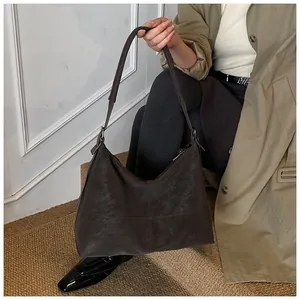 Detail of vintage dark brown tote bag with premium leather texture and stitching
