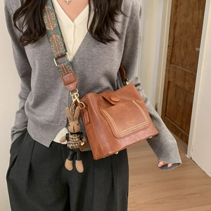 Brown leather crossbody bag with ethnic wide strap and cute bunny charm pendant