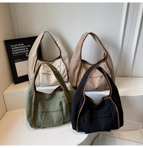 Detail of four corduroy tote bags with zipper pockets in white, khaki, green and black